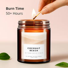 Load image into Gallery viewer, Candle labeled 'Coconut Beach' being lit with a match, on a light pink background.
