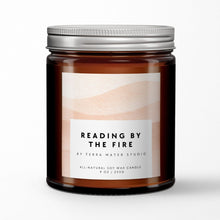 Load image into Gallery viewer, Soy wax candle jar labeled 'Reading by the Fire' by Terra Mater Studio on a white background
