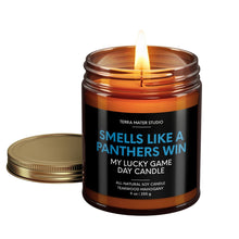 Load image into Gallery viewer, smells like a carolina panthers win scented candle with lid on side