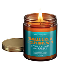Load image into Gallery viewer, smells like a miami dolphins win scented candle with lid on side