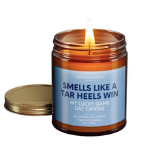 Load image into Gallery viewer, smells like a north carolina tar heels win scented candle with lid on side