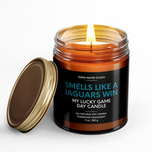 Load image into Gallery viewer, smells like a jacksonville jaguars win scented candle with lid on side
